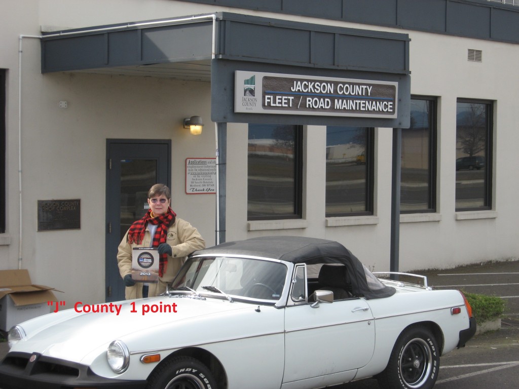 Here is a photo of my wife (co-pilot) by the Jackson county public road shop, submitted for bonus points. This looks like a fun event that many of our club members will participate in. Thanks! Don Evans, British Car Club of Southern Oregon