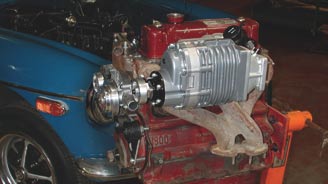 This is an early prototype mockup of the supercharger drive system. It's rugged and uses a four-rib serpentine belt. Moss includes a new alternator and a cast-iron water pump to ensure trouble-free operation.