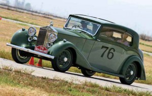Caption: Garrison Bielen not only won Best in Show with his '38 Rolls Royce, he also gets the unofficial "best attitude award from British Motoring. Dressed in full period attire, he even took his amazing Rolls out on the road course.