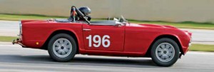 The trailer hitch looks a little out of place on a vintage race car, but not on Richard Taylor’s TR4. Richard drives the car to the track, often towing his Triumph motorcycle on a trailer. At the track, the windshield comes off and the race tires go on.